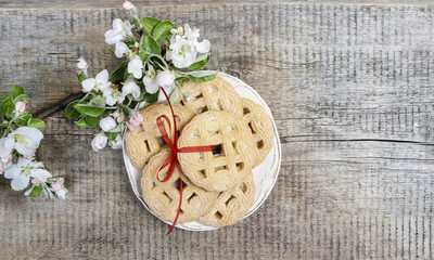 Top view of round cookies on wooden table. Apple blossom