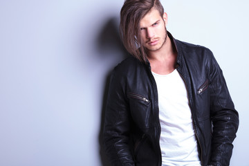 unshaved young fashion model in leather jacket