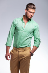 Fototapeta premium frowned casual man looks at you with hand in pocket