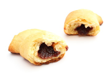 Fresh and sweet croissant with plum jam on white background