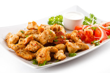 Grilled meat and vegetables on white background