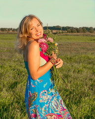 Woman with wild flowers smiling
