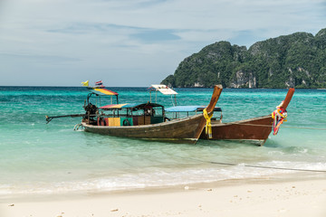 Fototapeta na wymiar thai longtail boats anchored in the surf on ko phi phi thailand