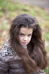 Naklejka premium Autumn portrait of a beautiful little girl