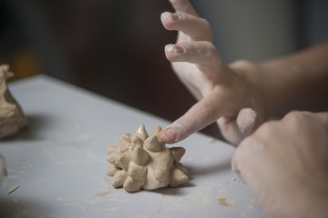 Girl make toy from clay