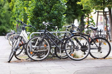 Fototapeta na wymiar Old bicycles in stack at square in town