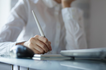 Woman designer using a graphics pad with notebook