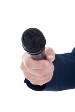 journalist's hand holding a microphone isolated on white