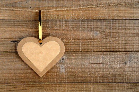 Paper heart on wooden background