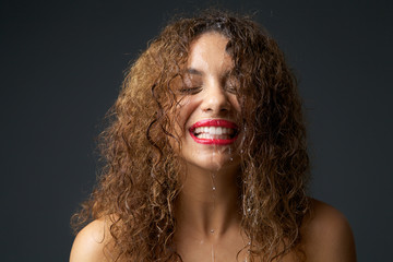 Portrait of a young woman with water dripping from face