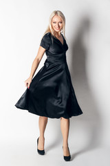 Fototapeta premium beautiful woman in elegant silk dress in fashion pose. studio s