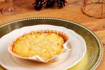 Stuffed scallop shell on a Christmas table