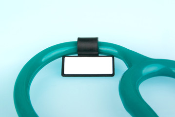 Stethoscope with ID tag on blue background