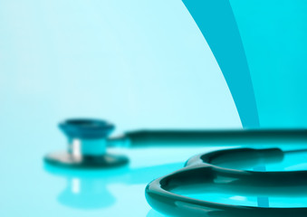 Stethoscope on blue, reflective background