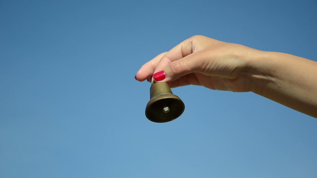 hand shake jingle small iron bell on blue sky