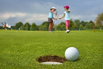 Golf, ball lying on the green next to hole