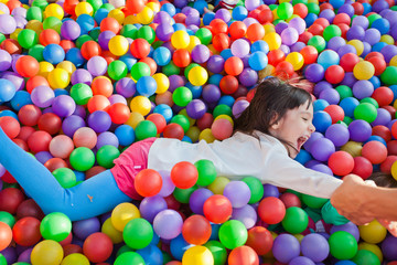 Fototapeta na wymiar little children on the background of many small balls