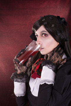 Portrait of a woman in retro costume, with wine