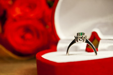 Engagement coposition - ring and roses on wooden surface