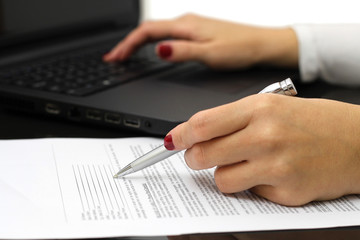 close up of female business hands working on  document and lapto