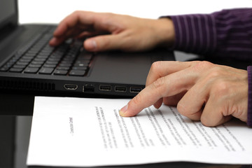 Obraz na płótnie Canvas Businessman working on contract with laptop