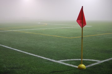 The view from the red corner flag on a football field in fog
