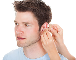 Person Adjusting Hearing Aid