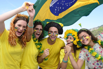 Group of happy brazilian soccer fans commemorating victory.