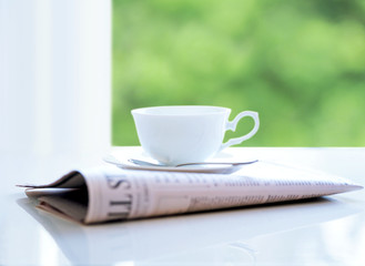 newspaper and coffee cup