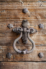 Door with decorative nails on wooden door consumed