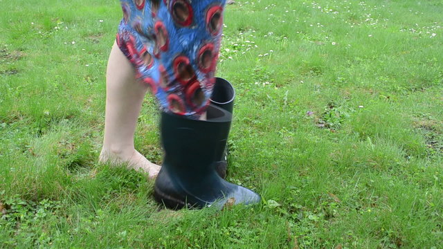 barefoot woman on meadow grass boot welly rubber shoes and walk