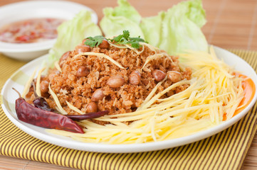 Crispy catfish with green mango salad, popular food in Thailand.