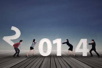 Businesspeople arrange new year 2014