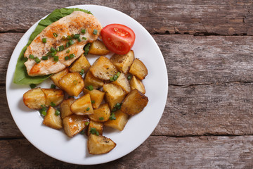 grilled chicken steak with potatoes and vegetables. top view