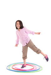 Young girl playing with hula hoop isolated over white background