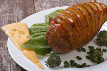 Sliced ​​baked potato with bacon and cheese