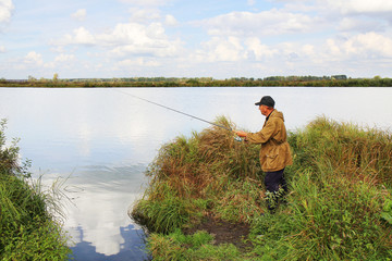 old fisherman with spinning rod