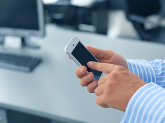 Close up of a man using mobile smart phone
