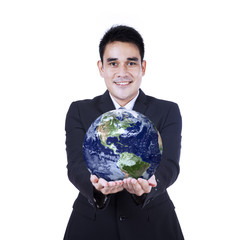 Isolated businessman holding a globe