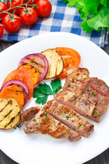 Steak with grilled vegetables on a plate