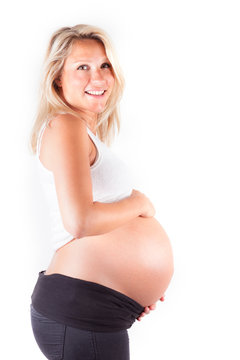 Beautiful pregnant blonde woman - isolated over a white backgrou