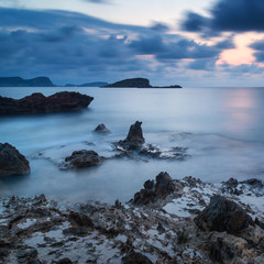 Stunning landscapedawn sunrise with rocky coastline and long exp