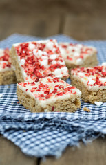 Strawberry and meringue topped flapjack on gingham cloth