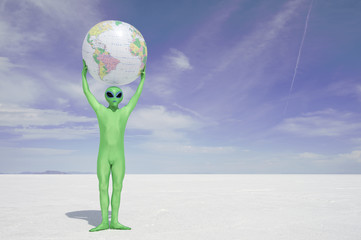 Green Alien Holds Earth Globe Above White Desert Planet