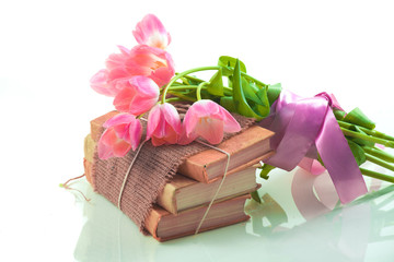 Pink tulips on old books