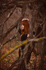 red-haired girl model woman in black dress dry autumn dark fore
