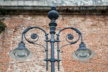 Black Iron Lamp by Old Brick Wall
