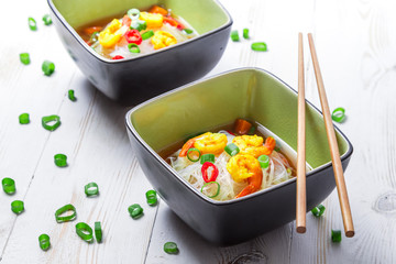 Two bowls of noodle soup with shrimp
