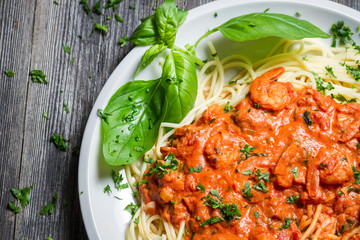 Spaghetti bolognese with seafood and basil