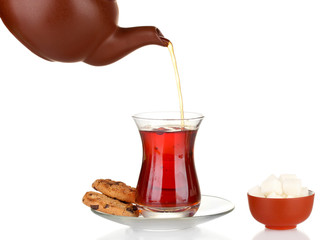 glass of Turkish tea and kettle isolated on white